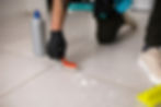 a man cleaning the grout with hand brush