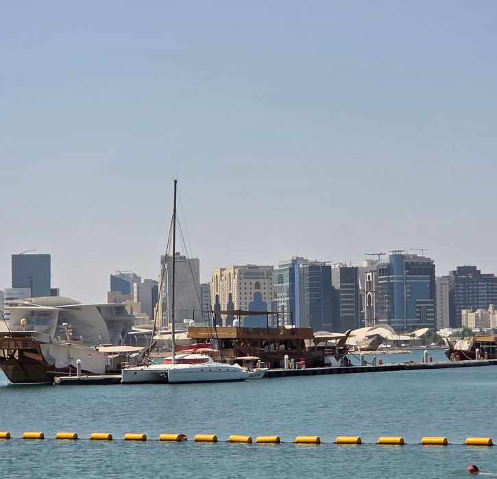 Private beachfront at Rixos Gulf Hotel Doha with clear turquoise waters and white sand.
