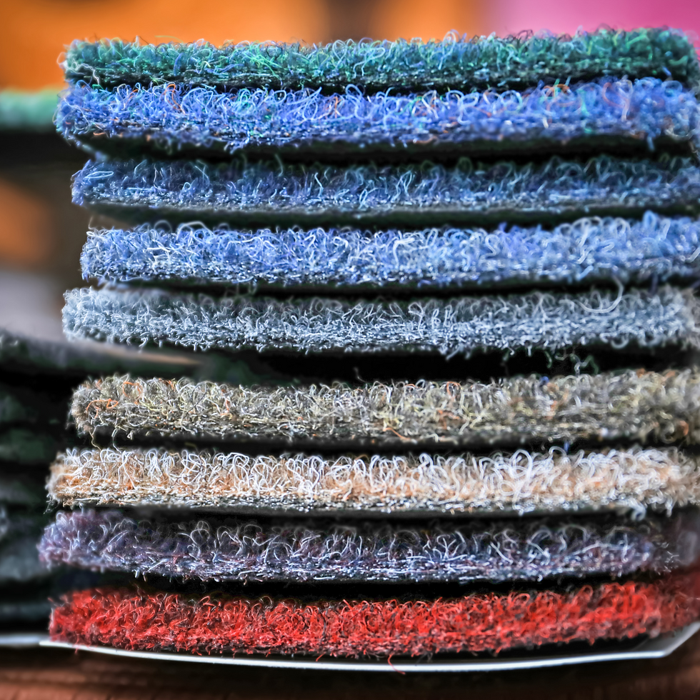 a stack of different colored carpet samples