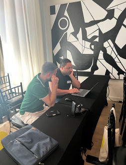 Two colleagues collaborate on laptop