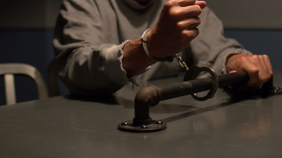 close-up-man-handcuffed-to-interrogation-room-table-SBI-351420711.jpg