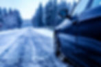 black-car-iced-road-surrounded-by-trees-covered-with-snow.jpg