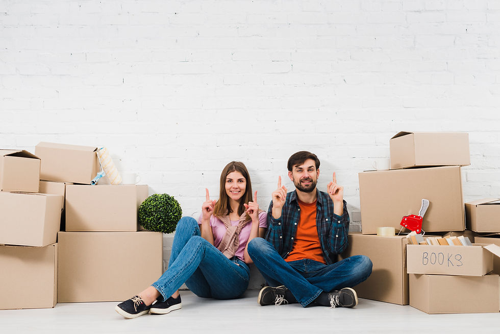 young-couple-sitting-floor-holding-their-fingers-upward-sitting-cardboard-boxes.jpg