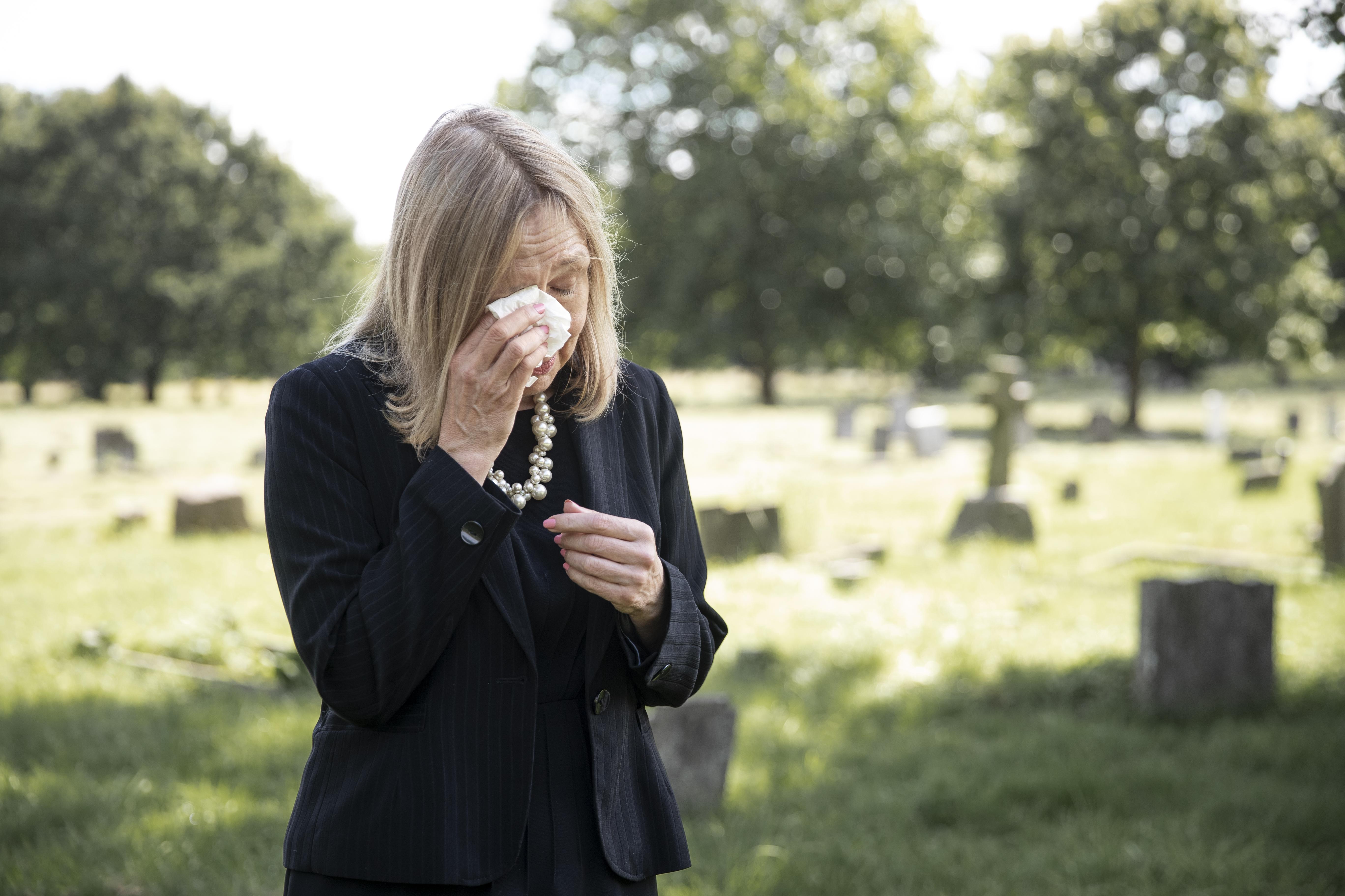 elderly-woman-visiting-grave-loved-one.jpg