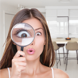 A woman looking through a magnifying glass