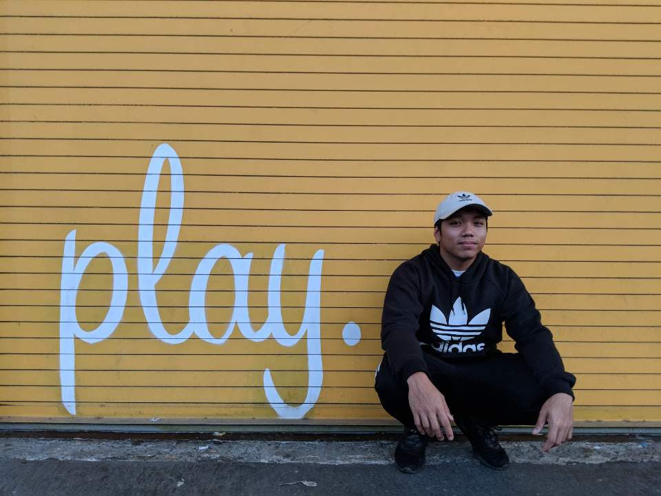 Man kneeling in front of wall