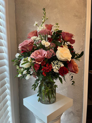 roses in hurricane vase