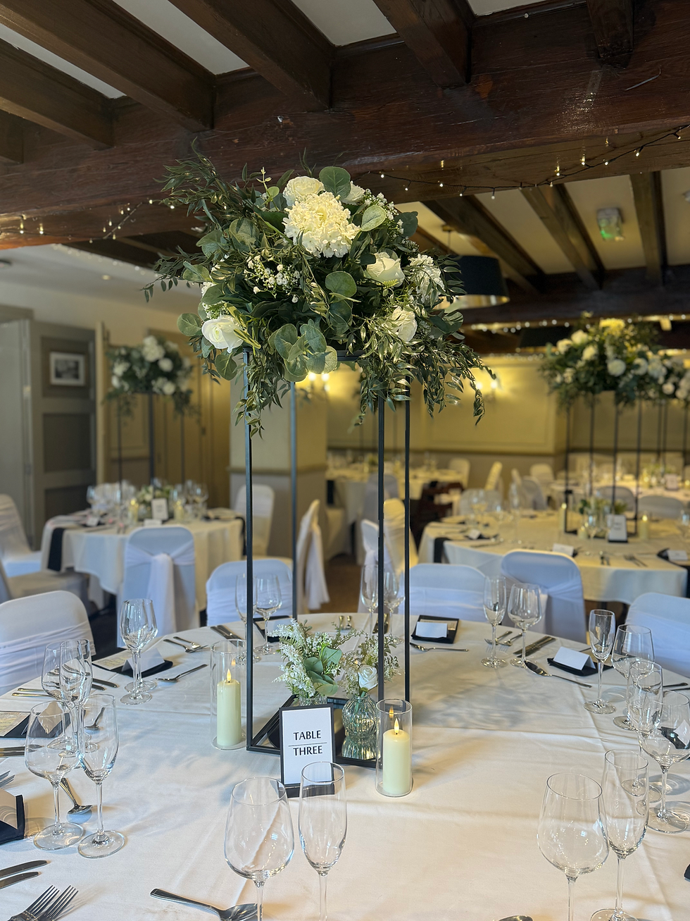 Tall floral arrangement on black stand