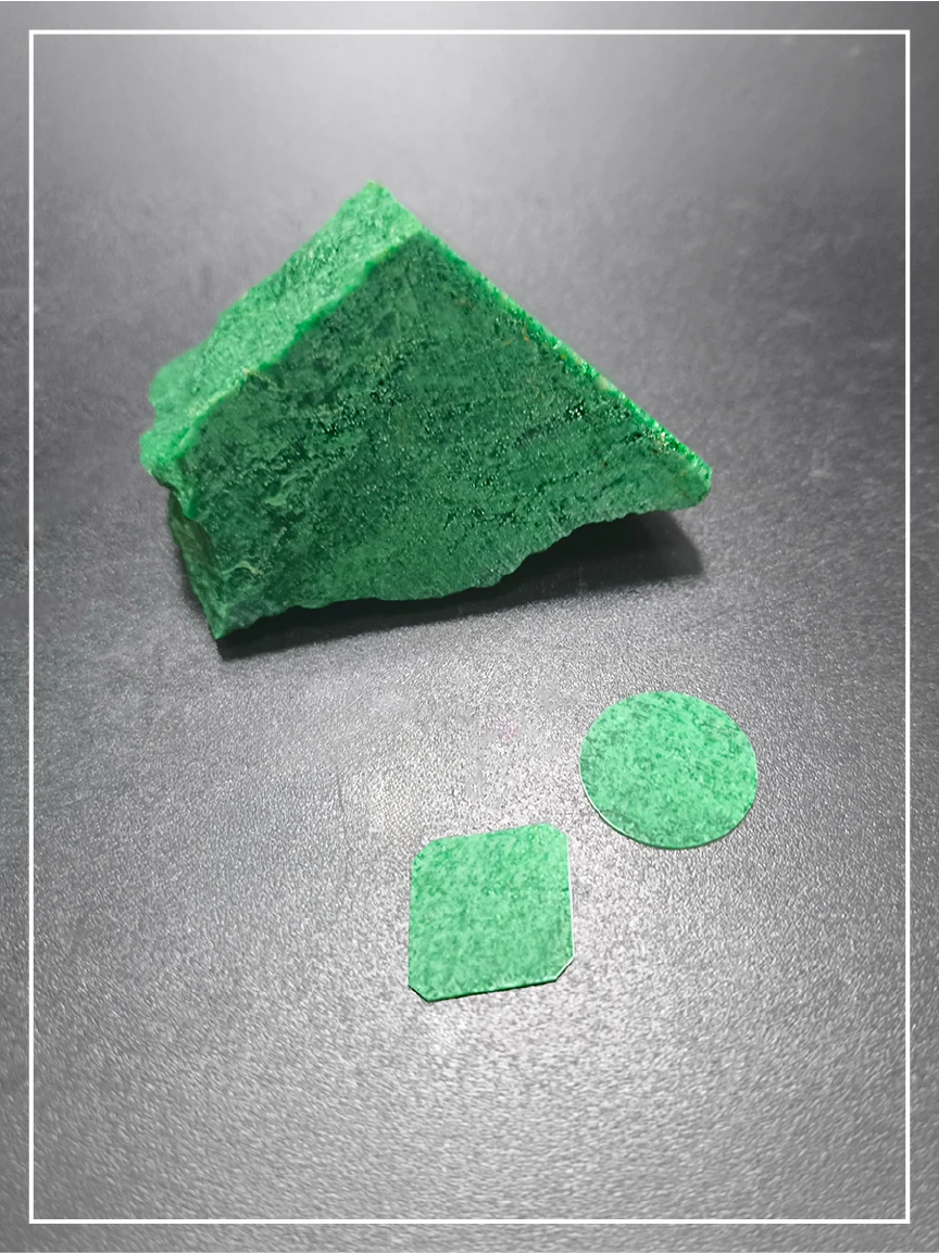 A stone block of Imperial Jade and thin Jade dials in front of it