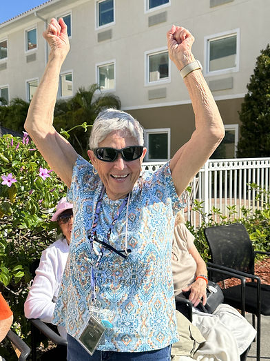 Nancy with Arms up Courtyard.jpeg
