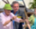 Executive Director Assisting Resident with Bow During Archery Activity