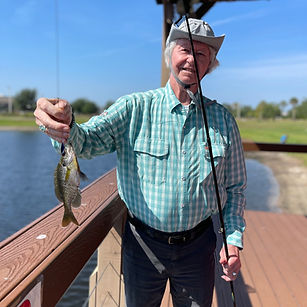Resident Holding the Fish he Caught from Lake Madeleine Pavilion