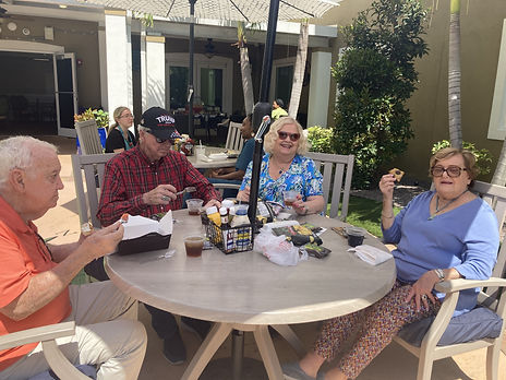 Residents Eatin Box Lunch Courtyard.jpeg