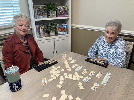 Smiling Residents Playing Rummikub in Anchors Aweigh