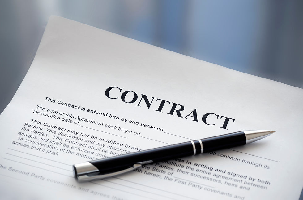Close-up view of a contract document with a pen on a wooden desk