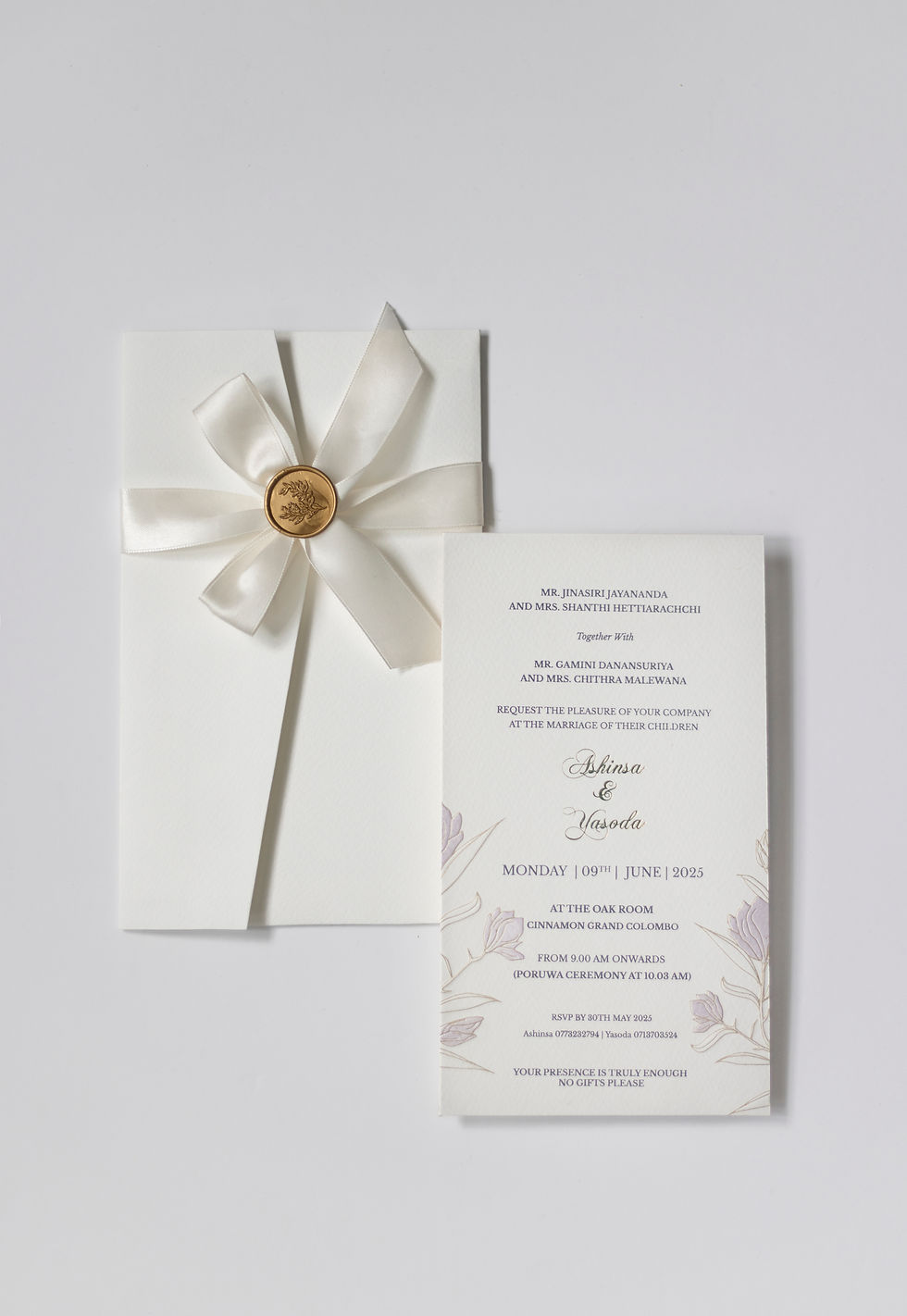 Eye-level view of a luxurious wedding invitation suite with gold foil and custom calligraphy