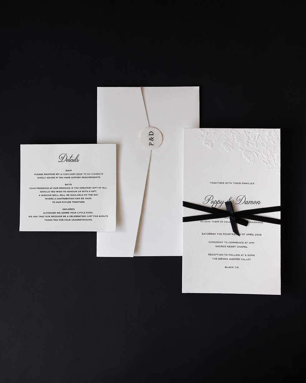 Close-up view of a luxurious wedding invitation with gold foil accents