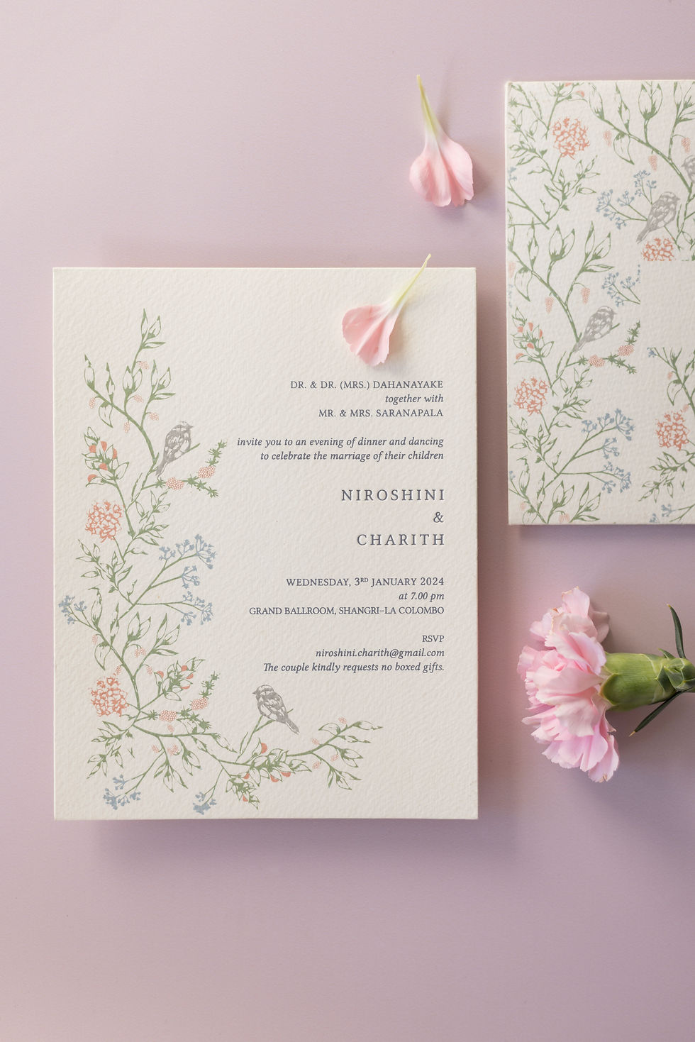Eye-level view of a custom wedding invitation suite with floral illustrations