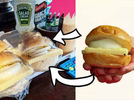 A split image showing a batch of plastic-wrapped cheese and onion sandwich rolls on a kitchen counter on the left, with white arrows pointing to a close-up cutout of a single sandwich being held up on the right, showcasing a thick slab of cheese and a raw onion slice.