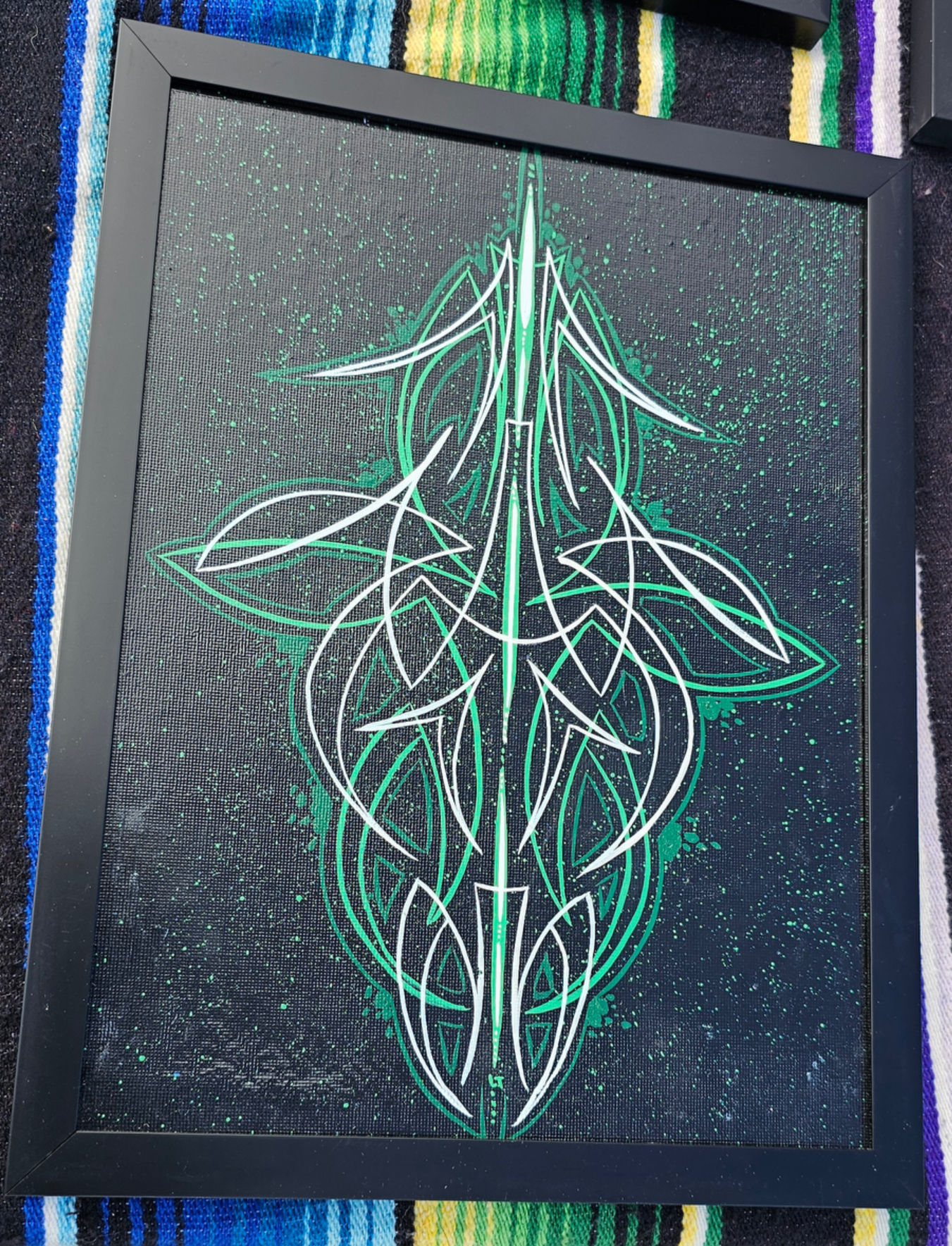 Framed canvas pinstripe art green/white on black