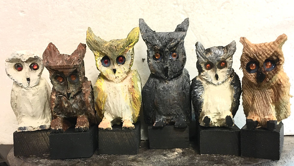 Four carved owl figurines