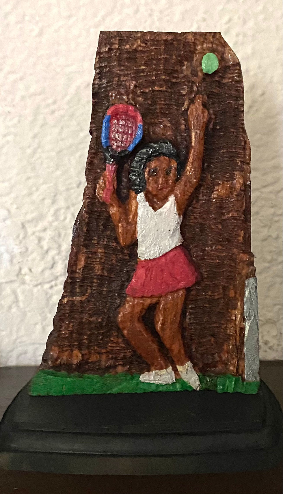 Wooden sculpture of tennis player