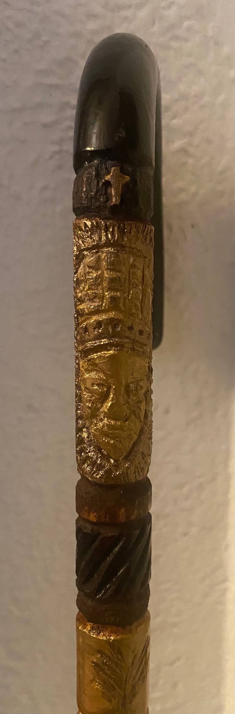 Gold-painted walking stick with carved face