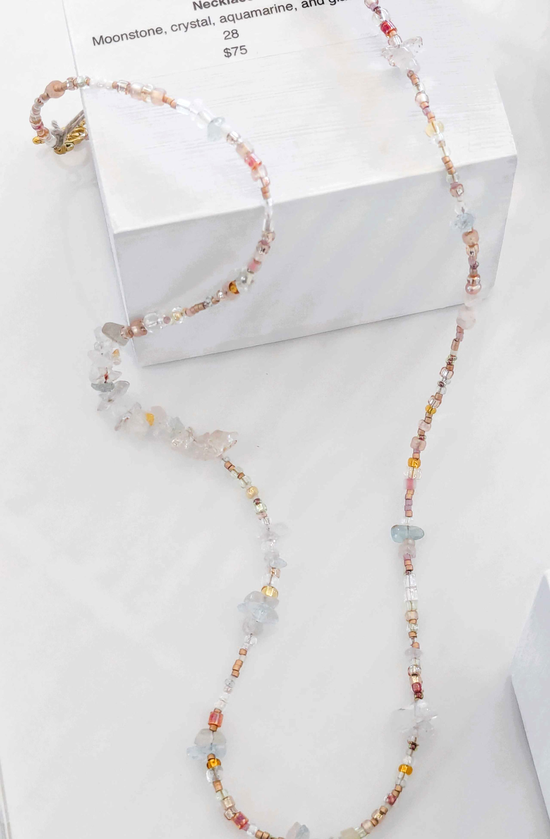 Long beaded necklace with light-colored beads
