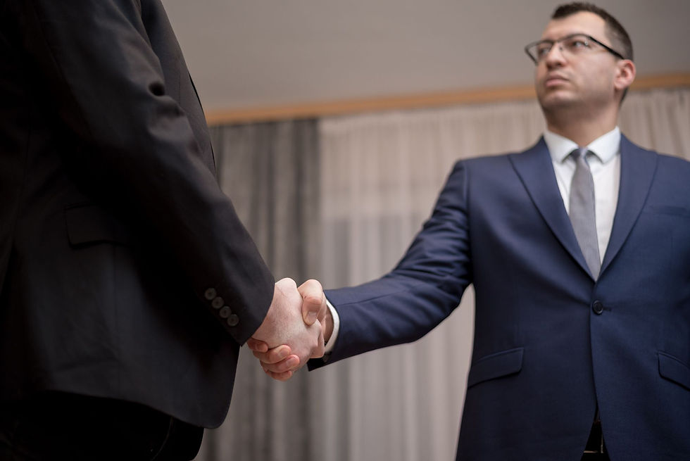 Two businessmen shaking hands after renegotiating an IT contract