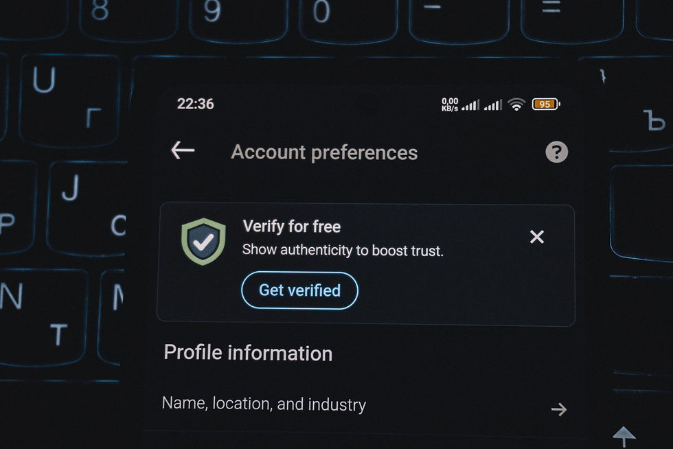 Phone showing an account verification prompt, a reminder that MFA tops the list of cyber insurance requirements