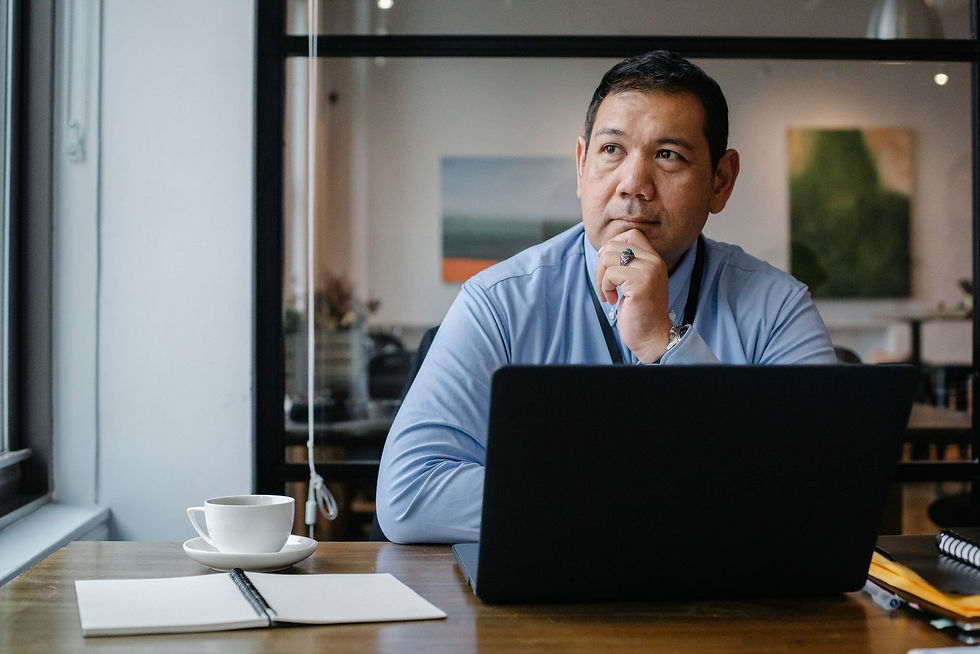 Businessman at his laptop thinking through common cyber insurance questions