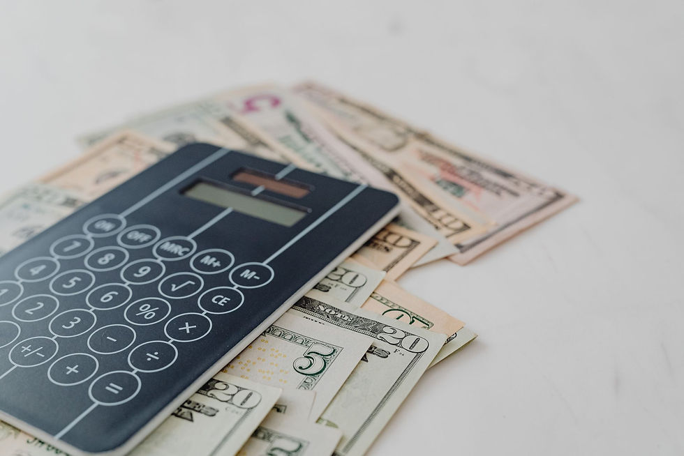 Calculator and US dollars showing what Copilot and ChatGPT really cost a business