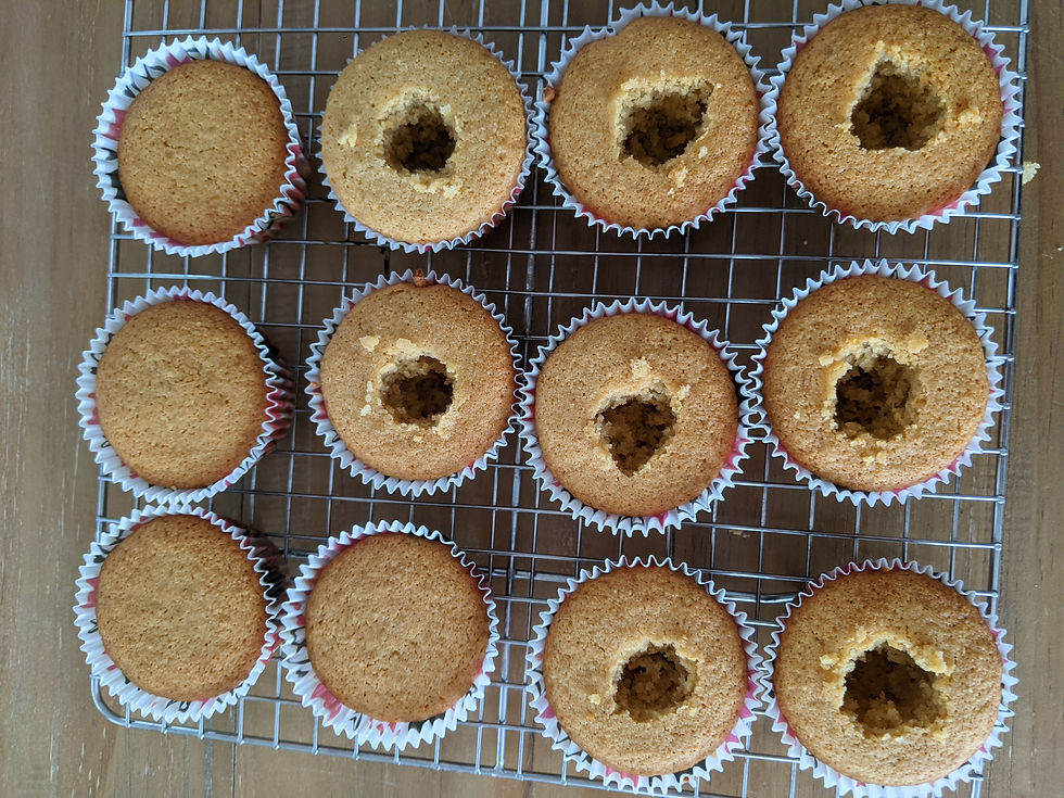 The cup cakes are shown with shallow holes in the middle. You are asked to cut a small, circle shaped hole about 2/3 of the way deep into the cupcake to make room for the filling.