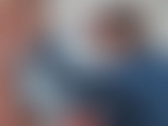 A handyman fixing a sensor with a drill