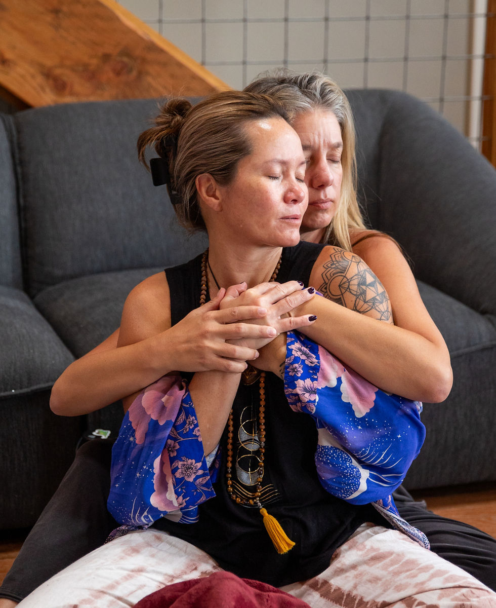 Two women holding each other in tantra workshop