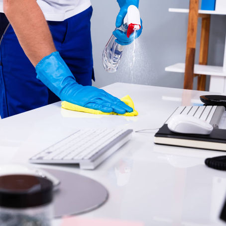 janitor cleaning commercial building desk