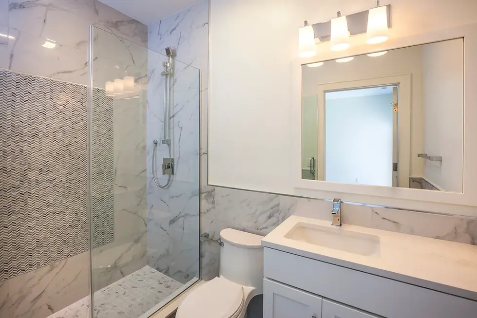 Contemporary bathroom with marble shower and vanity – 1381 East Putnam Ave apartments, Greenwich, CT.