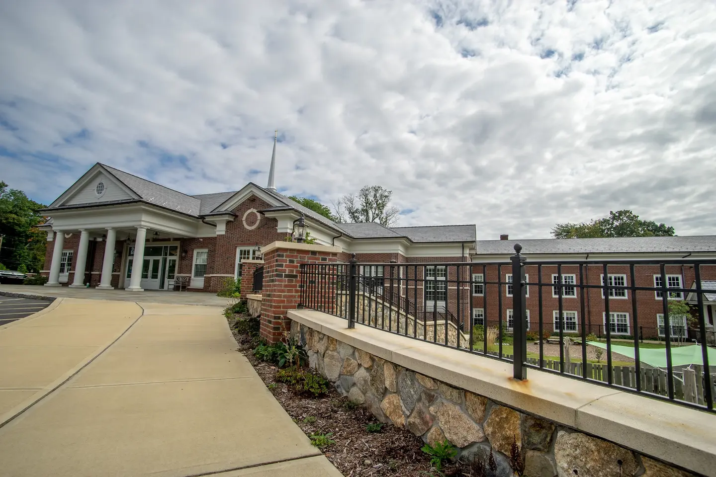 Brick building with walkway under cloudy skies, 860 Canal Street, A Pappajohn Company.