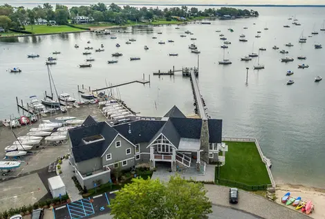 Boats docked at the pier with a building; Clubs & Organizations; coastal scene