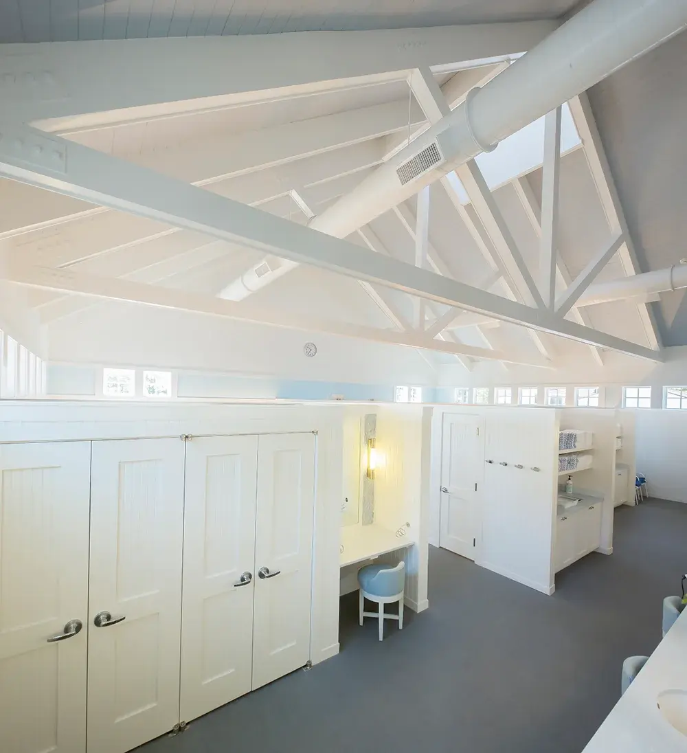 White-themed room with cabinets, desk, and chair; bright, airy, modern Beach Point Club.