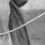 Thumbnail: Charcoal drawing of a woman in medieval clothing preparing to draw a bow. The focus is on her hands as she grips the arrow an