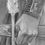 Thumbnail: Charcoal drawing of a woman in medieval clothing preparing to draw a bow. The focus is on her hands as she grips the arrow an