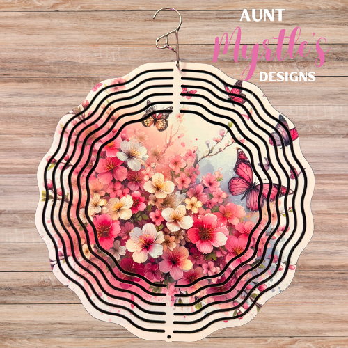 Pink floral wind spinner with blooming flowers and butterflies in soft watercolor shades of pink, cream, and blush.
