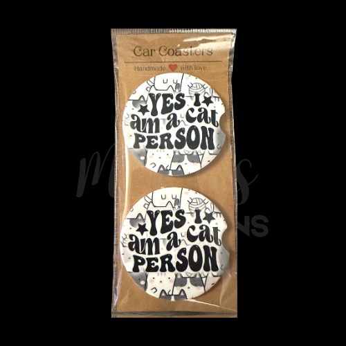 Set of car coasters featuring the phrase "Yes, I am a cat person" on a playful background of illustrated cats.