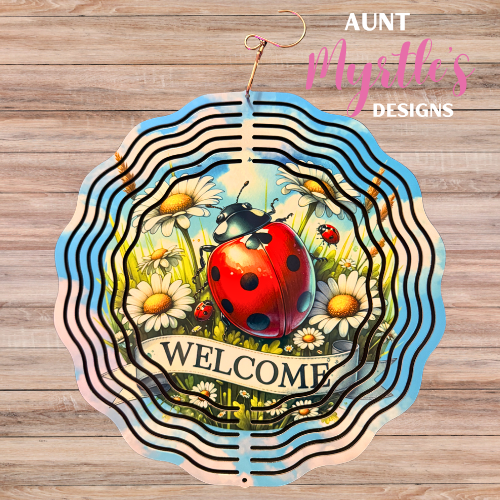 Metal wind spinner featuring a bright red ladybug, daisies, and a welcome sign in a cheerful garden scene.