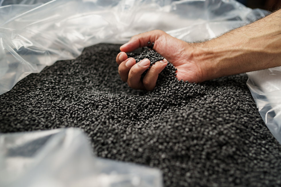 Close up of male hand holding plastic polymer granules.jpg
