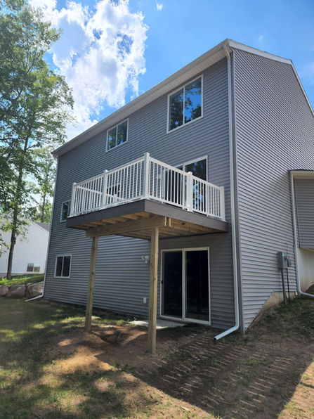 two story composite deck with railing on a house in Fremont, Michigan.
