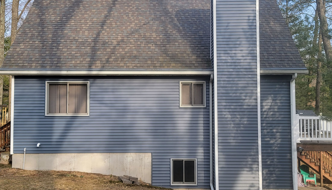 Vinyl monogram siding replacement due to storm damage on a home in Bitely, Michigan.