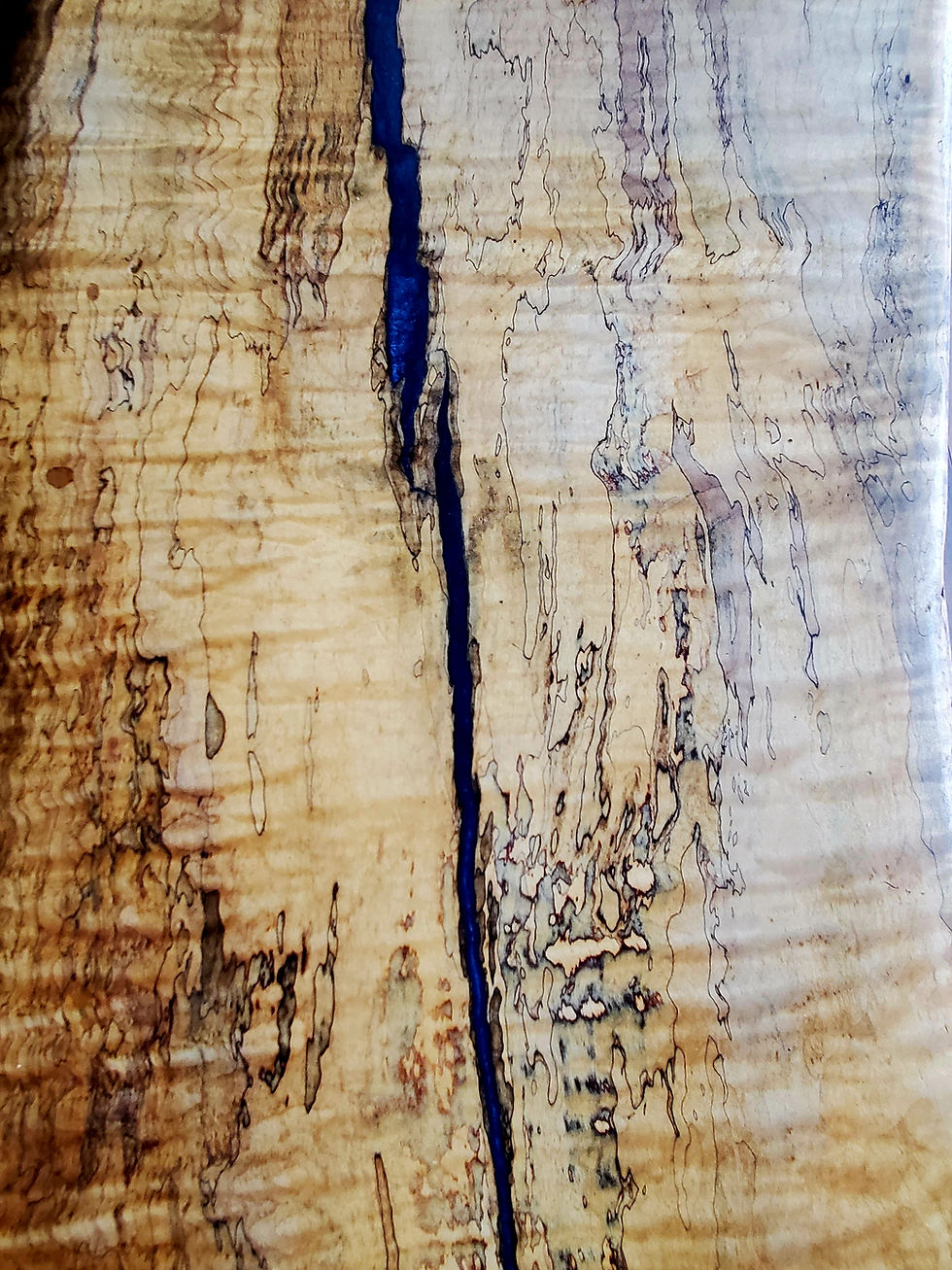 Close-up of a live edge table with blue resin inlay