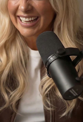 Claire Sinclair recording content with a microphone for Manifest with Claire